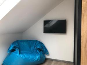 a blue bean bag chair in a room with a television at Kanino in Monschau