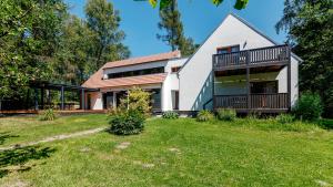 a house with a large yard in front of it at Penzion Blanko in Nová Bystřice