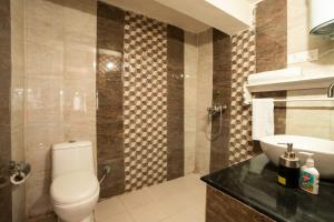 a bathroom with a toilet and a sink at LiveAway Ramgarh, Nainital in Rāmgarh +18 photos