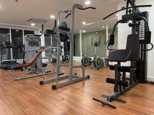 a gym with several exercise equipment in a room at Kampar Bonvoy Champs Elysees 4pax Homestay in Kampar