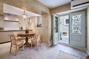 a kitchen and dining room with a table and chairs at Boutique holiday home Casa Ars Natura II in Grožnjan