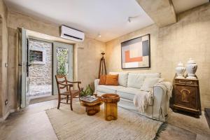 a living room with a white couch and a table at Boutique holiday home Casa Ars Natura II in Grožnjan