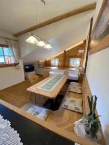 a living room with a wooden table in a room at Apartments Unteradamerhof in Sesto