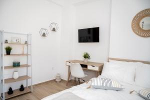 a bedroom with a desk and a bed with a chair at "Calm Joy & J" - Infinity in Ermoupoli