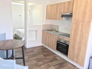 a small kitchen with a table and a sink at Merlimont-plage: studio in Merlimont