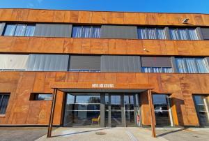 a building with the entrance to the first library at Aux Ateliers in Miserey-Salines