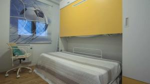 a hospital room with a bed and a chair at La Casa de San Miguel by Toledo AP in Toledo