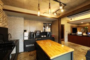 a kitchen with a wooden counter top in a room at Cornerstone Hotel in Seogwipo +49 photos