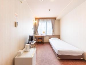Postel nebo postele na pokoji v ubytování Tabist Business Hotel R Side Kanazawa