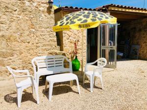 a table and two chairs and an umbrella at Il Giardino Degli Angeli in Presicce