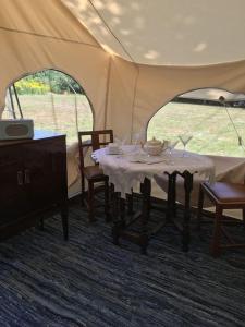 a tent with a table and chairs in it at Amelia Vera in Lincolnshire