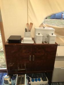 a wooden cabinet with utensils on top of it at Amelia Vera in Lincolnshire