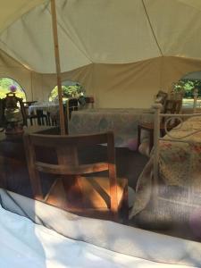 a tent with chairs and a table and a couch at Amelia Vera in Lincolnshire
