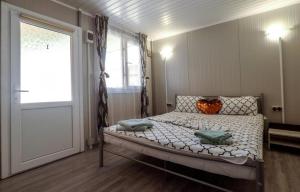 a bedroom with a bed and a window and a door at Cazare Sulinaa in Sulina