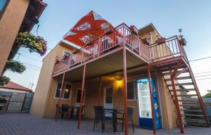 a building with a balcony and a table and chairs at Cazare Sulinaa in Sulina