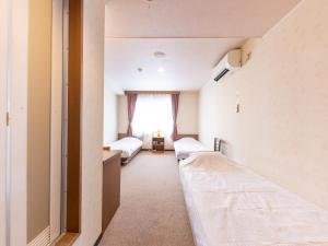 Postel nebo postele na pokoji v ubytování Tabist Business Hotel R Side Kanazawa