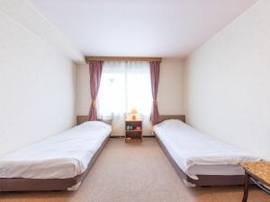 Postel nebo postele na pokoji v ubytování Tabist Business Hotel R Side Kanazawa