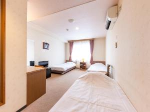 Postel nebo postele na pokoji v ubytování Tabist Business Hotel R Side Kanazawa