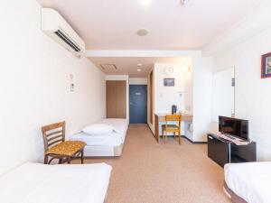 Postel nebo postele na pokoji v ubytování Tabist Business Hotel R Side Kanazawa