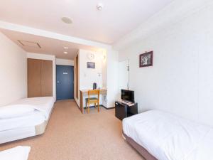 Postel nebo postele na pokoji v ubytování Tabist Business Hotel R Side Kanazawa