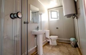 a white bathroom with a toilet and a sink at Cazare Sulinaa in Sulina