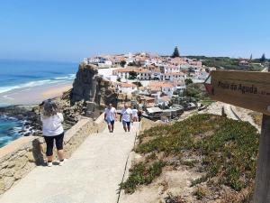 a group of people walking down a path on a cliff at Casa Mateus - Colares, Parque Natural Sintra Cascais in Sintra