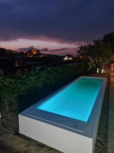 a swimming pool in the middle of a backyard at night at Villa Laura in Castellinaldo