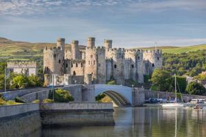a large castle with a bridge over a river at Ocean Pearl Apartment by Seaside Llandudno in Llandudno