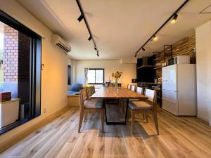 a kitchen and dining room with a table and chairs at Shirakabanoyado - Minato in Osaka