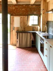 a kitchen with a sink and a stove at Thomashof Klein-Mutz in Zehdenick