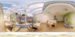 ein Raum mit Tischen und Stühlen und einem großen Fenster in der Unterkunft ART HOTEL HOUSE ONE in Baden-Baden
