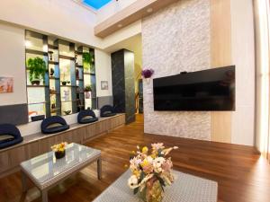 a living room with a flat screen tv on a wall at 1881 Ya ka Hostel in Tainan