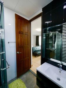 a bathroom with a shower and a sink and a door at Basic Line Villa เบสิค ไลน์ วิลล่า in Chiang Mai +99 photos