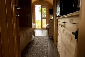 a small room with a bed and a window at Ivy hill Glamping Pod in Ennis