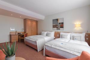 Tempat tidur dalam kamar di Select Hotel Tiefenthal