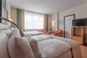 Tempat tidur dalam kamar di Select Hotel Tiefenthal