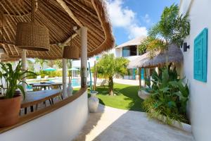 a resort with a patio with tables and umbrellas at Villa Palapa Samui in Bophut 