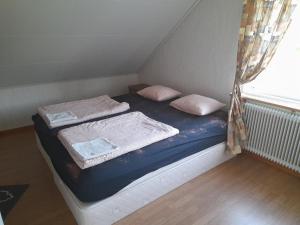 a small bed in a room with a window at House next door the Arctic Circle in Överkalix