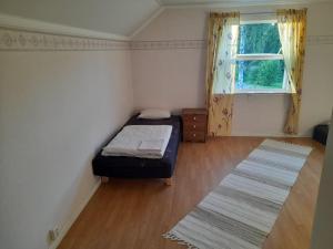a small bedroom with a bed and a window at House next door the Arctic Circle in Överkalix