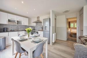 a kitchen and living room with a white table and chairs at Host & Stay - Robin's Nest in Gunnislake