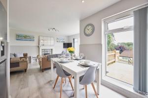 a kitchen and living room with a white table and chairs at Host & Stay - Robin's Nest in Gunnislake