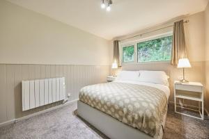 a bedroom with a large bed and a window at Host & Stay - Robin's Nest in Gunnislake +9 photos