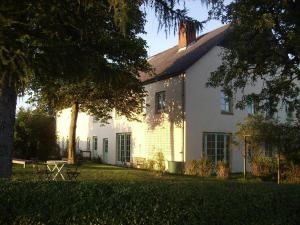 a white house with a tree in front of it at Hof Rodenkrog in Lütjenburg +28 photos