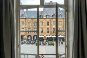 a view of a building from a window at Suites Mana - Bleu Pacifique - Vue sur Place Ducale avec Parking privé inclus in Charleville-Mézières +22 photos