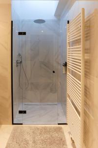 a shower in a bathroom with a glass shower stall at HUIS19 Luxury apartments in Ghent
