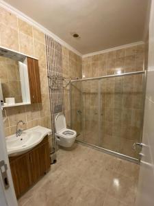 a bathroom with a shower and a toilet and a sink at SÜMELA HOLİDAY HOTEL in Macka