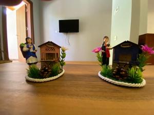 two figurines of people standing next to houses on a table at SÜMELA HOLİDAY HOTEL in Macka