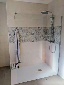 a shower in a bathroom with a tile wall at Casa Luzia in Miami Platja +12 photos