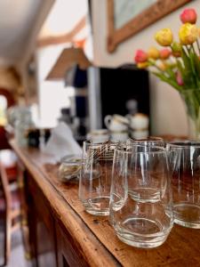 a row of wine glasses sitting on a counter at Sarenka in Białka Tatrzańska