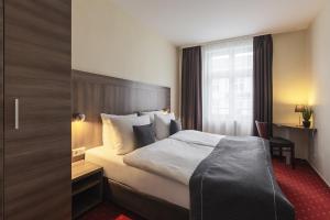 Ein Bett oder Betten in einem Zimmer der Unterkunft acora City Apart Living the City - Apartments